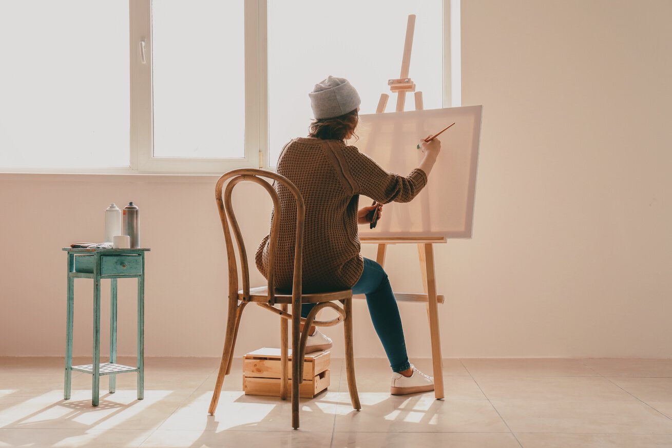 Female Artist Painting in Workshop